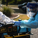 A medic loads a patient with covid-19 symptoms into an ambulance on August 5, 2020.